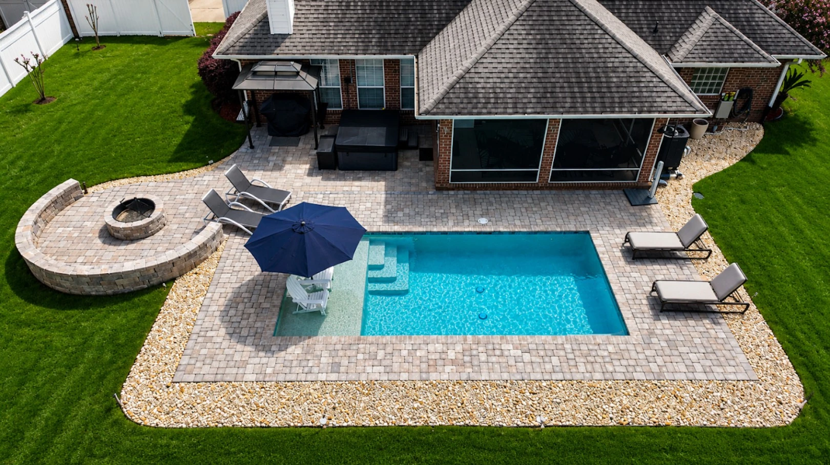 Neway Pools backyard pool with paver patio and fire pit